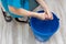 woman wringing out a wet rag with her hands while cleaning