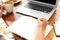 Woman writing blog content in notebook at table