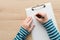 Woman writing on clipboard note pad paper