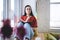 Woman writing in notepad sitting on windowsill