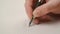 Woman writing notes in notebook, close up steady footage with selective focus on hand