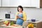 Woman writing shopping list on kitchen