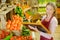 Woman writing sign for fruit and veg