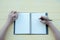 The woman wrote the book with a clay book in a yellow background. The top view