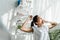 Woman yawning and doing morning exercise in bedroom