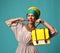 Woman yelling screaming and eating belt of hand hold stylish fashion yellow leather bag handba