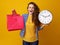 Woman on yellow background showing clock and red shopping bags