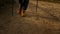 Woman in yellow boots hiking on dirt road. Front view female hiker trekking