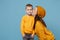 Woman in yellow clothes kissing kiss cheek cute child baby boy 4-5 years old. Mommy little kid son isolated on blue