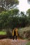 Woman in a yellow coat and hat in hand. Casual fashion