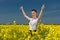 Woman in the yellow flower field show best gesture