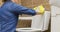 Woman in yellow gloves washing toilet with blue rag. Keeping house neat