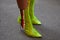 Woman with yellow green transparent high heel shoes before Ermanno Scervino fashion show, Milan