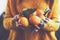 Woman in yellow knitted pullover with ripe clementines