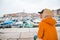 woman in yellow raincoat at rainy weather looking on rovinj city