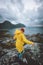 Woman in yellow raincoat walking in Norway mountains active vacations