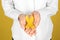 Woman with yellow ribbon on color background, closeup. Cancer awareness concept