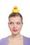 Woman with a yellow rubber duck on her head