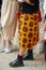 Woman with yellow skirt and black Dr Martens boots before Tiziano Guardini fashion show, Milan