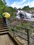 Woman yellow umbrella water montain