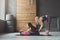 Woman with yoga instructor in class, asana cobbler pose