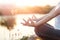 Woman yoga practicing and meditating by lake in summer