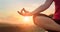 Woman yoga practicing and meditating by the lake in summer background