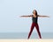 Woman yoga stretching at the beach