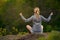 Woman Yoga. Young hikers relax in nature