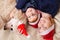 A woman, a young boy and a dog lie smiling in New Year`s hats. Pets in the family, companion dog. View from above