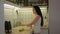 Woman young housewife washing fresh fruits in kitchen under water stream, preparation fruit salad