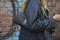 Woman with Yves Saint Laurent black lether bag and jacket before Fendi fashion show, Milan