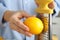 Woman zesting fresh lemon indoors  closeup view