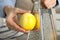 Woman zesting fresh lemon indoors, closeup view