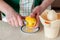 A Woman Zesting a Lemon