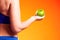 Womanin sportswear holding an apple. People, fitness and healthcare concept