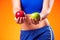 Womanin sportswear holding apples. People, fitness and healthcare concept