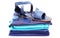 Womanly sandals and sunglasses on pile of blue clothes. White background