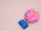 Womans bath sponge with soap on pink background