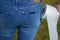 Womans bottom in jeans with toilet paper