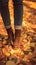 womans Closeup  feet in jeans and boots, autumn stroll