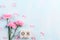 Womans day concept. Pink carnation flower with March 8 text on wooden block calendar on blue pastel wooden background