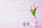 Womans day concept. Pink tulips and red heart with March 8 text on wooden block calendar on white wooden background