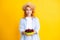 Womans enjoying a fresh sweet cherry. Female eating cherries on yellow background.