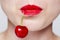 womans face with red lipstick and a cherry