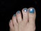 Womans feet painted with blue nail polish