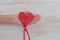 Womans hand with deflated heart shape balloon