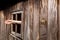 womans hand sticking out of a broken wooden window