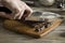 Womans Hands Chopping Chocolate Bar with Knife