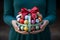 A womans hands hold a colorful box with a ribbon